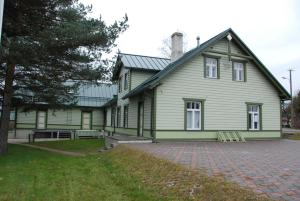 AvinurmeAvinurme Hostel的一座带砖车道的大型绿色房屋