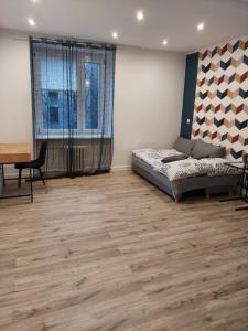 琴斯托霍瓦Apartament Premium的一间卧室配有一张床、一张桌子和一张桌子