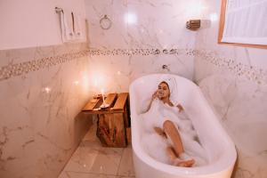 乌鲁班巴Inkasaire Boutique Lodge的坐在浴室浴缸里的女人