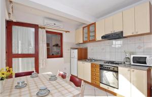 扎达尔米哈诺维卡4号公寓的一间带桌子和微波炉的小厨房