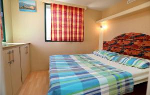 特罗吉尔Amazing stacaravan In Trogir With Kitchen的一间小卧室,配有床和窗户