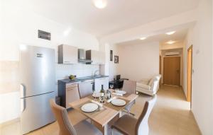 Djvulje2 Bedroom Gorgeous Apartment In Divulje的厨房以及带桌椅的用餐室。