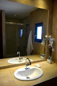 德里奥斯埃皮尼奥酒店的一间带两个盥洗盆和大镜子的浴室