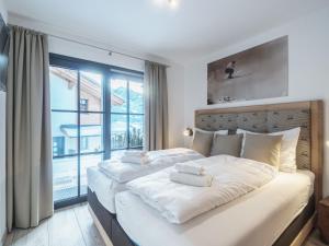 皮森多夫Luxurious holiday home in Piesendorf with sauna的一间卧室设有一张大床和大窗户