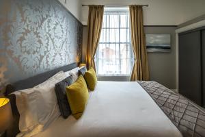 韦茅斯Gloucester House的一间卧室设有一张大床和大窗户