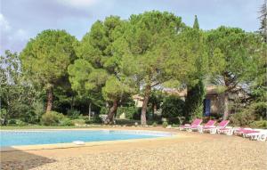 Saint-Pons-de-Mauchiens4 Bedroom Pet Friendly Home In St Pons De Mauchiens的游泳池设有粉红色的椅子和树木