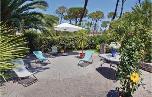 普林希匹纳马尔马雷玛度假屋的庭院配有桌椅和遮阳伞。
