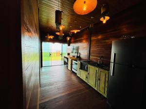 图托亚Chalé Rubi的一间铺有木地板的厨房和一台冰箱