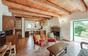 Badia TedaldaIl Fienile的一间厨房和一间带木制天花板及桌子的客厅
