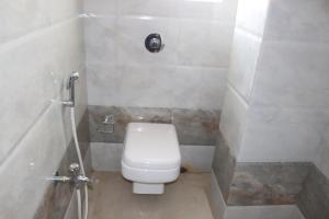 加尔各答Hotel Angina的一间带卫生间和淋浴的小浴室