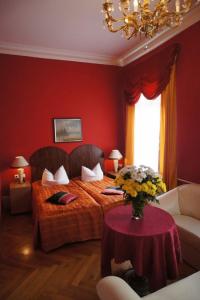海德堡海德堡景英酒店的一间卧室配有一张床和一张鲜花桌子