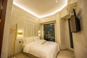 哥打京那巴鲁ACJ Residence @ Beside Cititel Hotel的卧室配有白色的床和窗户。