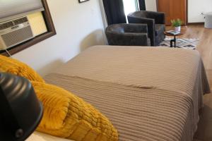 拉皮德城Cabin 5 at Horse Creek Resort的一间卧室,卧室内配有一张床和一把椅子
