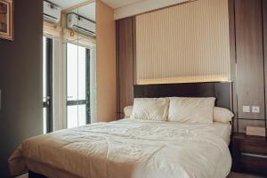 @Lexio.Stay - Luxury Condominium One Residence (Harris Hotel Batam Centre) with sea View (Singapore) + city View (Romantic)客房内的一张或多张床位