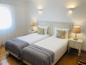 米尔芳提斯城Guarda Rios的卧室内的两张床,配有两张台灯。