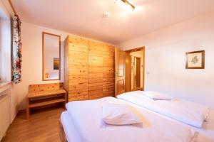 加尔米施-帕滕基兴Kreuzeck的一间卧室设有两张床和木墙