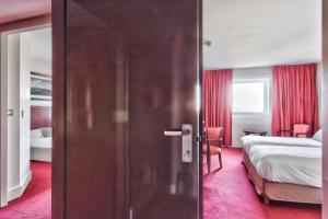 鲁瓦西昂法兰西巴黎戴高乐机场-维勒班特金色郁金香酒店的卧室和卧室的房门