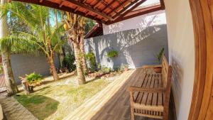 奥兰布拉recanto palmeira imperial Holambra SP的一个带木凳和棕榈树的门廊