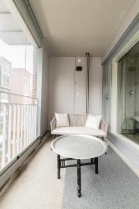 赫尔辛基Apartment, SleepWell, Tyynimeri with private parking and optional private sauna的阳台配有沙发和茶几