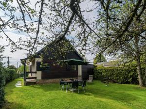 希尼Quaint Cottage in Chiny with Private Garden的院子里带桌椅的房子