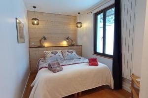 圣皮耶尔德沙尔特勒斯库策隆作坊旅馆的一间卧室配有带两个枕头的床和窗户