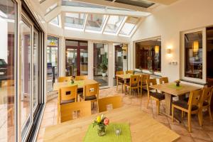Sessenbach沃尔夫莫特斯兰德酒店的餐厅设有桌椅和窗户。