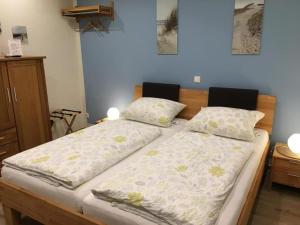 阿默灵豪森Ferienwohnungen Heideidylle的一间卧室配有两张带枕头的床。