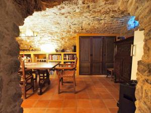 赫罗纳Masia with pool and beautiful views near Girona的一间位于洞穴内的带桌椅的用餐室