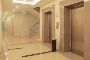 PadangsidimpuanHotel Mutiara Mitra RedDoorz的楼内走廊,有楼梯间和门