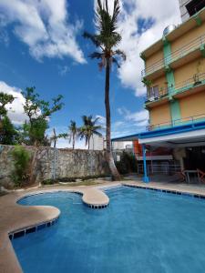 宿务宿务市新城公园酒店的棕榈树酒店前的游泳池