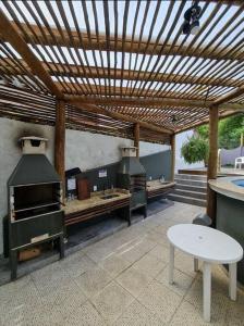 圣保罗Afras Maresias的庭院设有带木制凉亭的户外厨房。