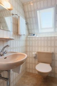 艾因西德伦KunstHotel Linde Garni的一间带水槽和卫生间的浴室以及窗户。
