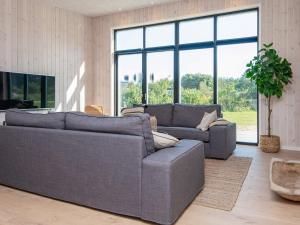 格莱斯堡16 person holiday home in Glesborg的客厅设有两张沙发和一个大窗户