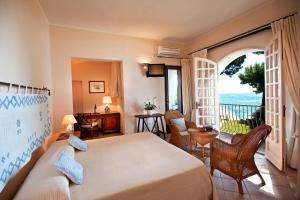 圣玛格利特迪普拉桑树酒店的一间卧室配有一张床,享有海景