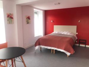 塞夫勒河畔圣洛朗Les Papoulis的红色的卧室,配有一张红色墙壁的床