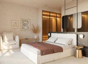 天堂海滩Eden View Suites & Villas的卧室配有一张白色大床和一把椅子