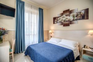 罗马Hotel Ottaviano Augusto的酒店客房设有蓝色的床和窗户。