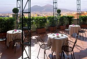 那不勒斯特米努斯星际酒店的市景阳台配有桌椅。