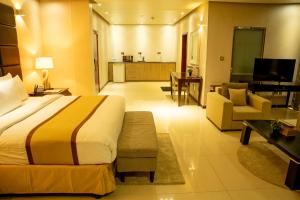 朱巴Palm Africa Hotel Juba的酒店客房设有床和客厅。