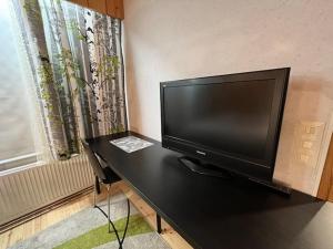TikkakoskiHuoneisto Tikkakoski - Apartment in Tikkakoski的靠窗边桌子上的平面电视