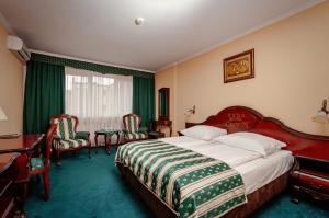 索哈切夫肖邦酒店的酒店客房,配有一张床、一张桌子和椅子