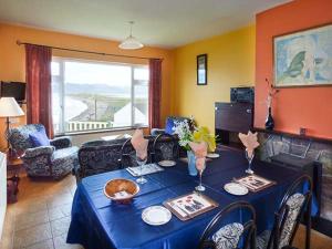 罗斯贝Rossbeigh Beach Cottage No 6的客厅配有一张带蓝桌布的桌子