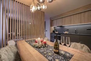 什平德莱鲁夫姆林Savoy Exclusive Mountain Apartment的用餐室配有带酒瓶和玻璃杯的桌子