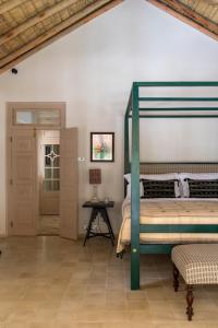坦加拉Halcyon Mawella的一间卧室配有绿色双层床和一张桌子