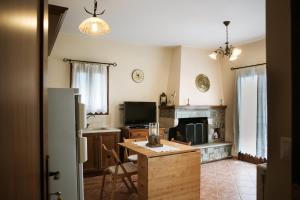 扎戈拉Feels like home apartment in Zagora的厨房配有冰箱、桌子和壁炉