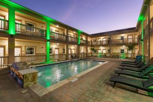 南帕诸岛El Delfín Lodge的绿灯环绕的酒店庭院中的游泳池