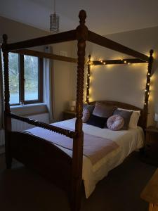 韦斯特波特Secluded hilltop hideaway!的一间卧室配有一张带灯光的木床