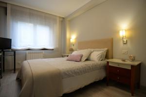 奥莱罗斯A Coruña - Playa Santa Cristina, Perillo-Oleiros的一间卧室设有一张大床和一个窗户。
