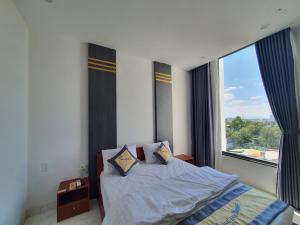 邦美蜀Song Anh Hotel的一间卧室设有一张床和一个大窗户