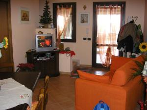 圣维托罗卡波Baglio Makari的客厅配有橙色沙发和电视